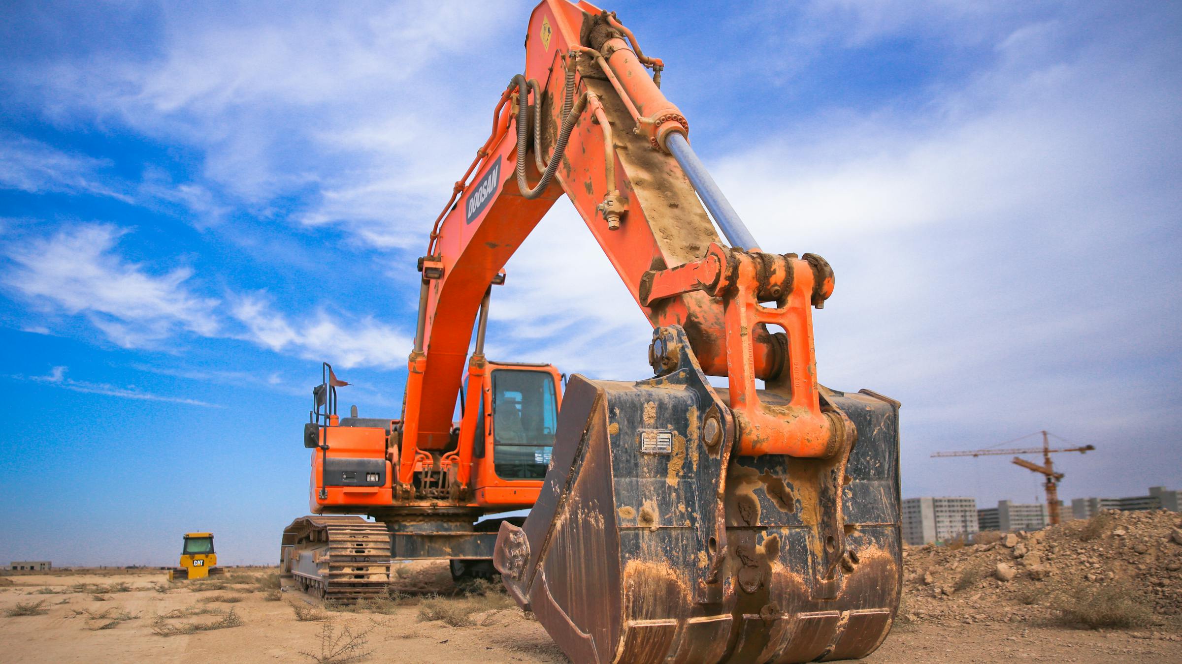 Excavator on a construction site under a bright sky